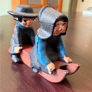 Vintage Cast Iron Amish Couple Sledding Figurines